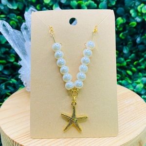 Pearl crystal gold necklace with starfish pendant.